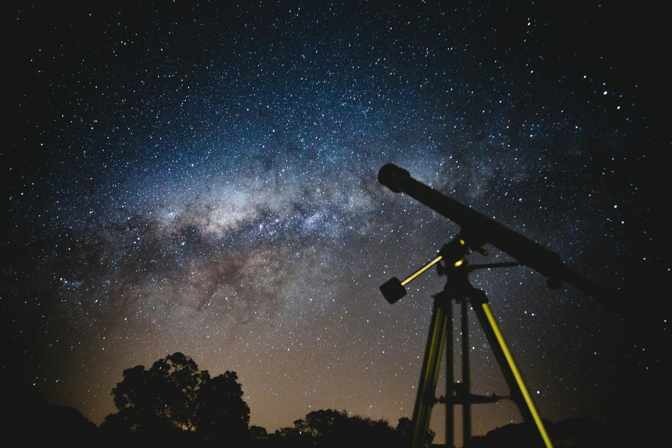 Stunning starry sky with silhouette of telescope capturing the Milky Way in Brazil.